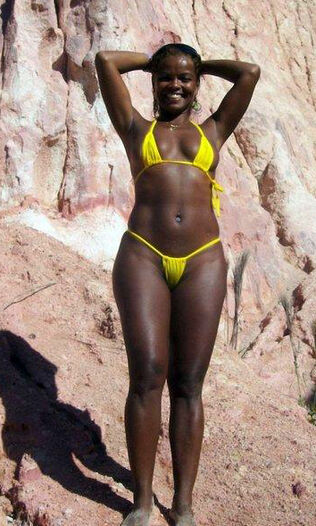 Afro woman on a beach. she's a