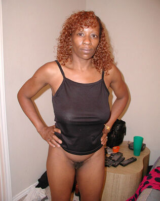 Curly ebony dame with flabby udders